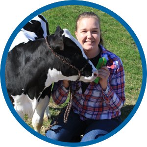 Female trainee posing with a dairy cow